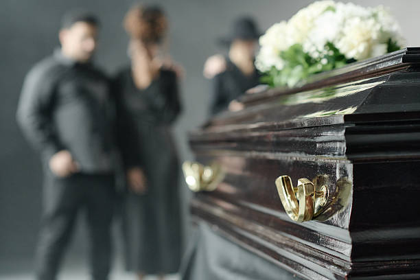istock Multiethnic Group Mourning Beside Coffin during Funeral Ceremony Indoors 2238055783