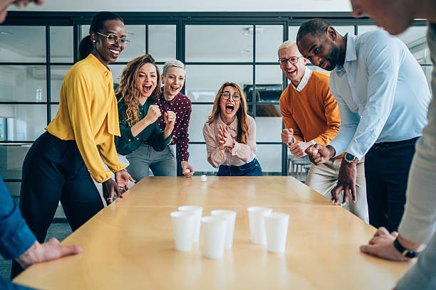 istock Young colleagues playing beer pong in the office. 2238058305