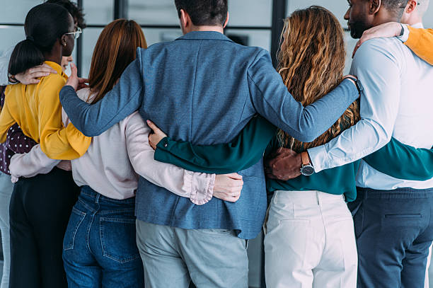 istock Back view of embraced business team in the office. 2238058357