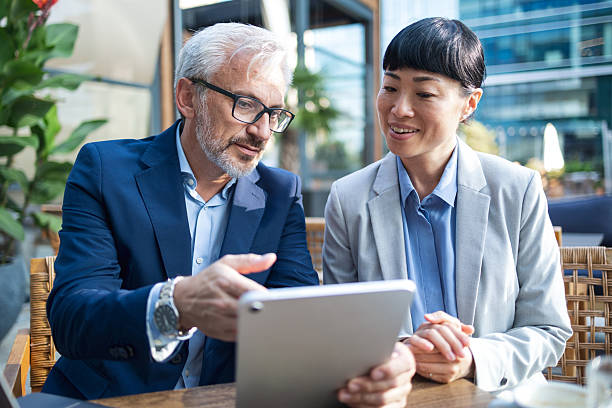 istock Business colleagues discussing data on digital tablet outdoors 2238058898