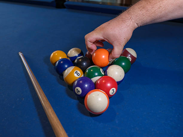 istock Aligning billiard balls on the table before starting game 2238058977