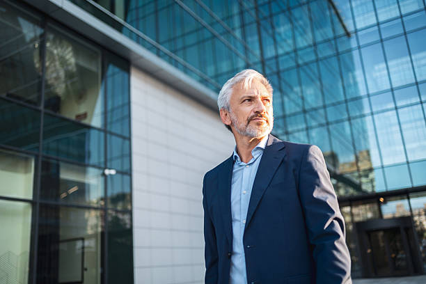 istock Mature businessman standing outside modern corporate building 2238059025