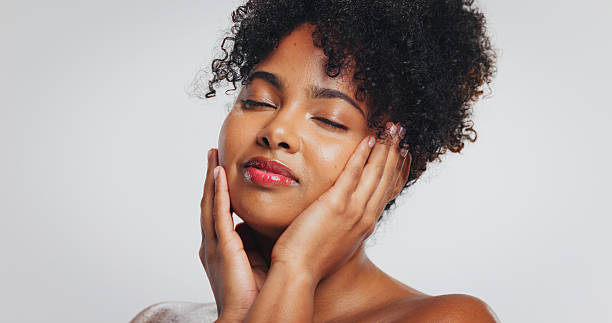 istock Beauty, calm and woman with lipstick, studio or color for self expression, moisturizer or cosmetics. White background, relax and skincare with dermatology for black person, makeup and glow of face 2238060168