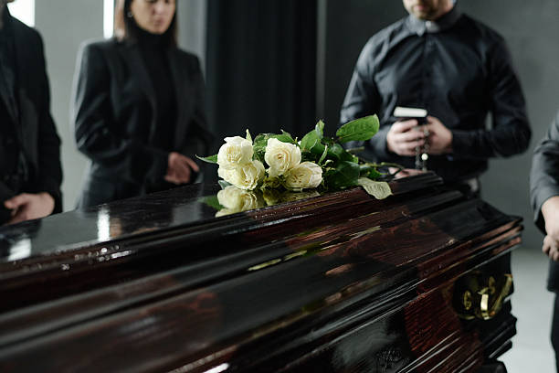 istock Group of Adults Mourning Beside Coffin during Funeral Ceremony 2238061087