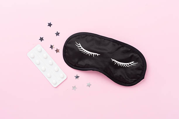 istock Sleeping mask with pills on color background, top view 2238067647