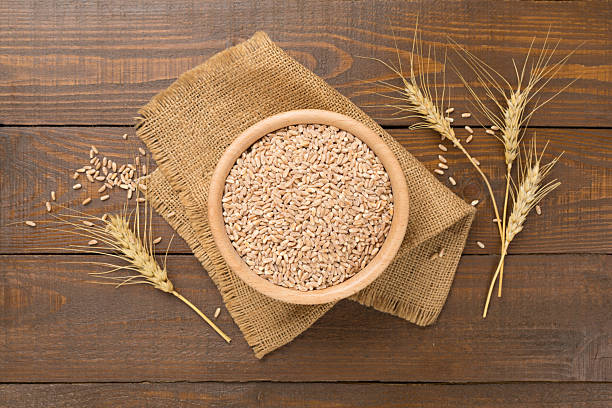 istock Bowl with spelt grain on wooden background, top view 2238067682