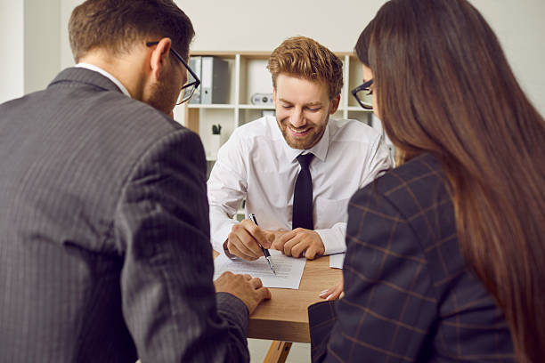 istock Confident business man going to sign some documents at the office reaching agreement with partners. 2238071014