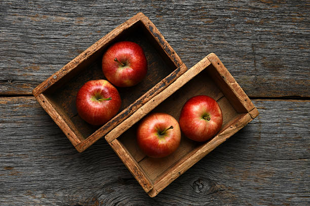 istock Two rustic wood boxes with gala apples on an old wooden table. 2238075140
