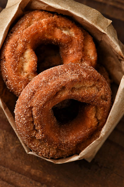 istock A brown paper bag filled with fresh baked Apple Cider Donuts. 2238075864