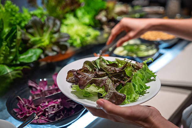 istock Close-up of fresh salad being served at buffet 2238076192