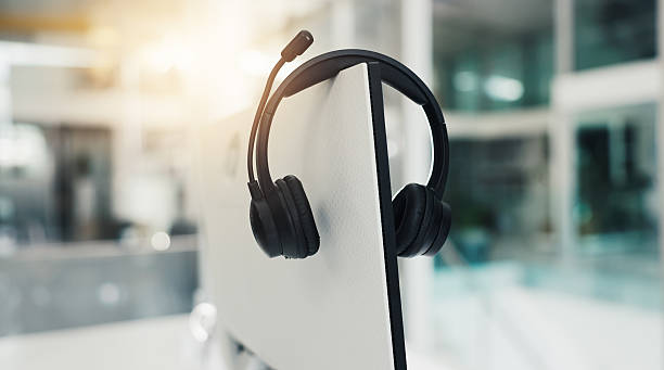 istock Call center, computer and mic with headset in empty office for virtual assistance, crm and help desk. Communication, contact us and hotline support with headphones for lead generation and flare 2238077479