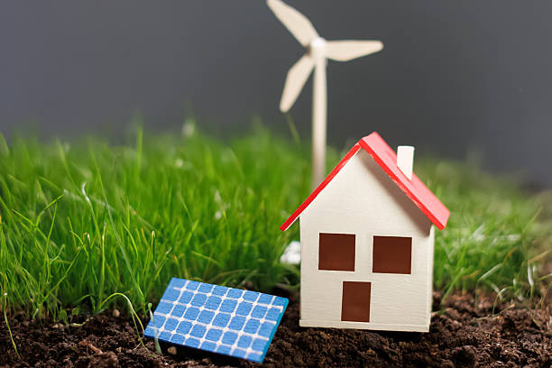 istock Model representing renewable energy with a house, wind turbine, and solar panel on a neutral background 2238077736