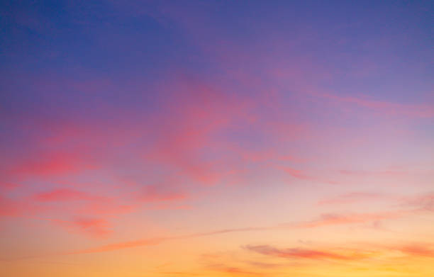 istock Dramatic purple and orange clouds fill the sky during either sunrise or sunset. 2238077826