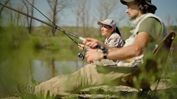 istock Outdoor Hobbies. Man Teaches Woman To Fish 2238077986