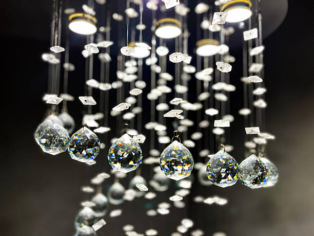 istock Diamond-cut crystals of a chandelier sparkle under house lighting 2238077995