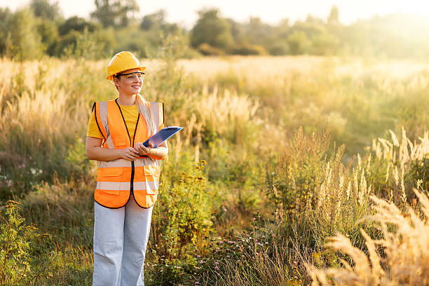 istock Female environmental worker with clipboard in a sunny meadow 2238078371