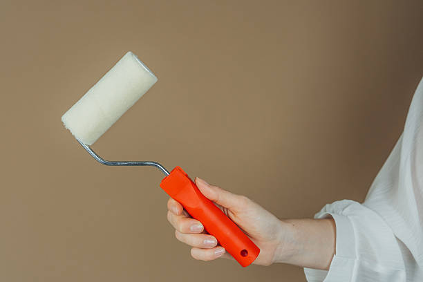 istock Red handle roller in hand with white shirt for painting tool and household concept 2238078868