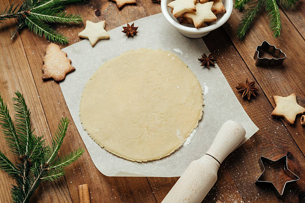 istock Festive cookie dough and baking setup on wooden table for christmas culinary and rustic food concept 2238078926