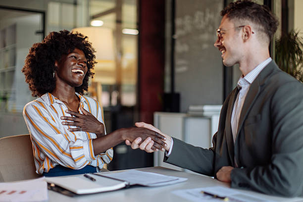 istock Joyful Business Interaction Between Two Professionals Shaking Hands at a Meeting 2238079586