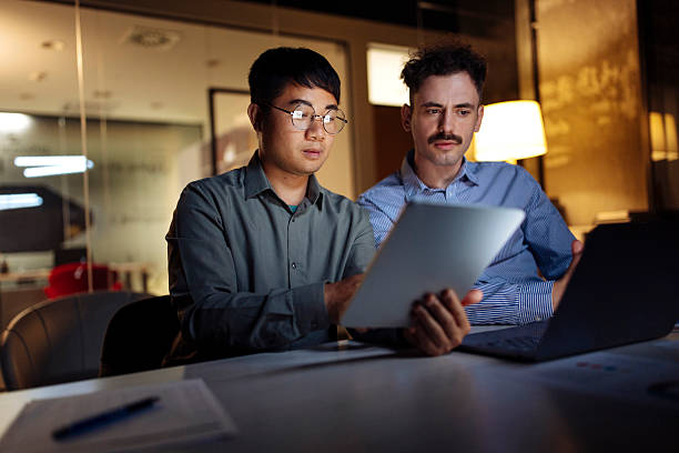 istock Two Professionals Engaged in Collaboration at Modern Office Setting 2238079615
