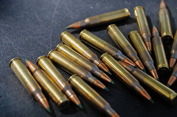istock long-barreled gun bullets on the table 2238079623