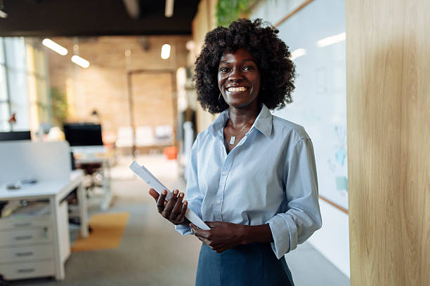 istock Confident Professional Standing in a Modern Office Holding a Tablet 2238079880