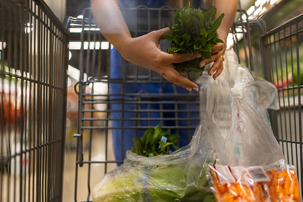 istock Female Nurse in Uniform Shopping Outdoors Preparing for Work with Fresh Vegetables and Herbs 2238087646
