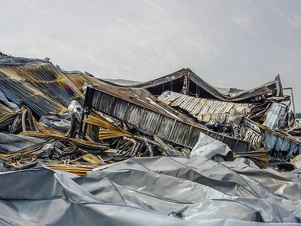 istock Dramatic scene of a building completely destroyed by a devastating fire, with smoldering debris. 2238088050