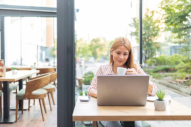 istock Attractive Woman with Laptop Drinking Coffee Indoors 2238089397