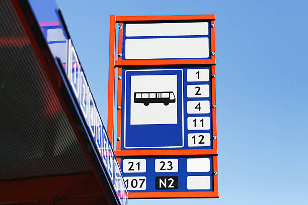 istock Bus stop sign with timetable numbers. Public transportation board against clear blue sky background. 2238090514