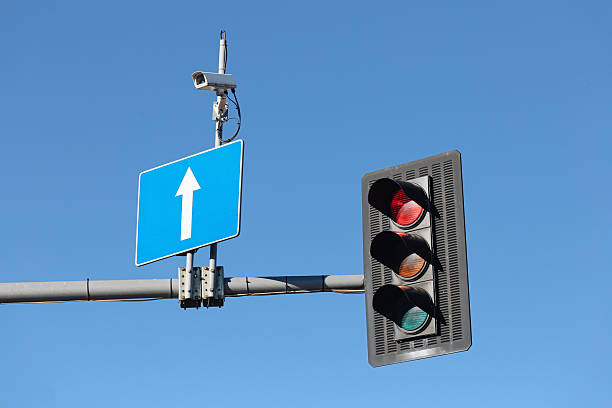 istock Traffic light with blue directional sign against clear sky. Urban transportation system for regulation of vehicles and bicycles. 2238090515