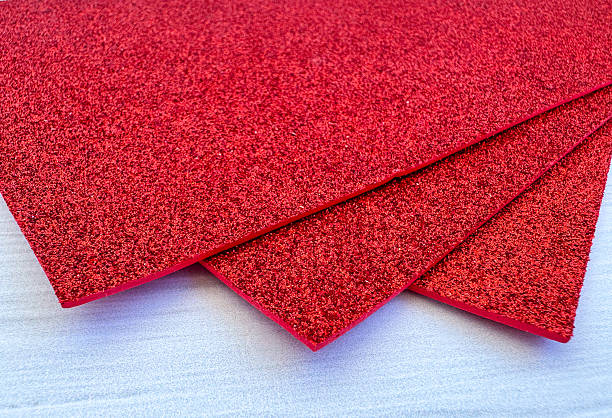 istock Red shiny foam sheets on white wooden background 2238091349