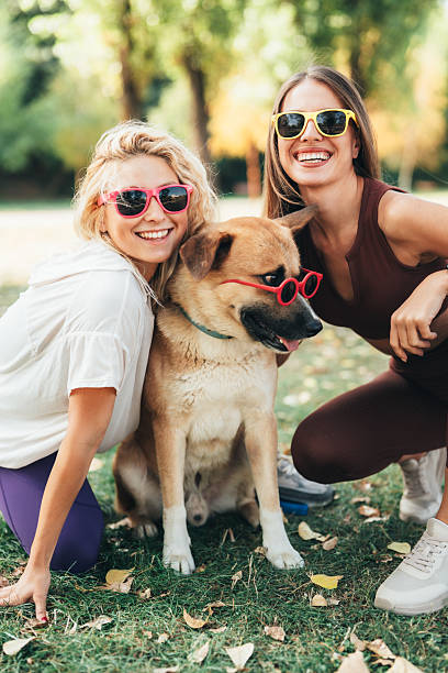 istock Best friends having fun with their cool dog 2238091660