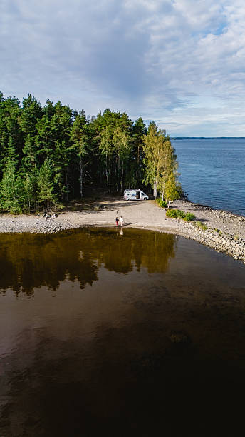 istock Tranquil summer scene at Lake Saimaa with camper van and lush forest views 2238092508