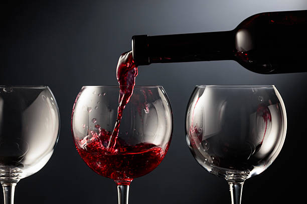 istock Pouring red wine into a wine glass. 2238092695