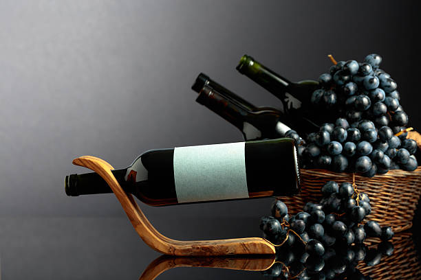 istock Red wine and blue grapes on a black reflective background. 2238092707