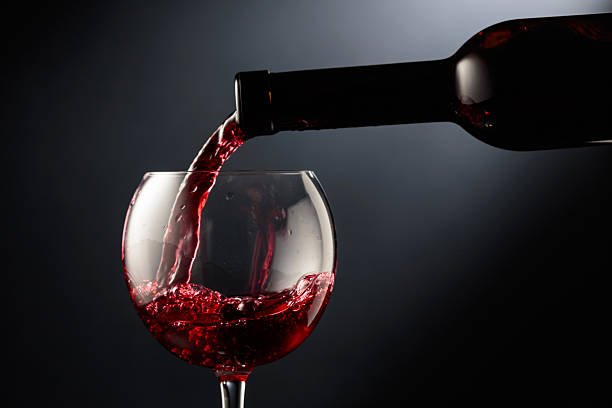 istock Pouring red wine into a wine glass. 2238092711