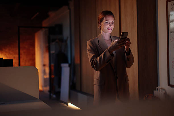 istock Professional Woman in an Office Using Her Smartphone During Evening Hours 2238093319