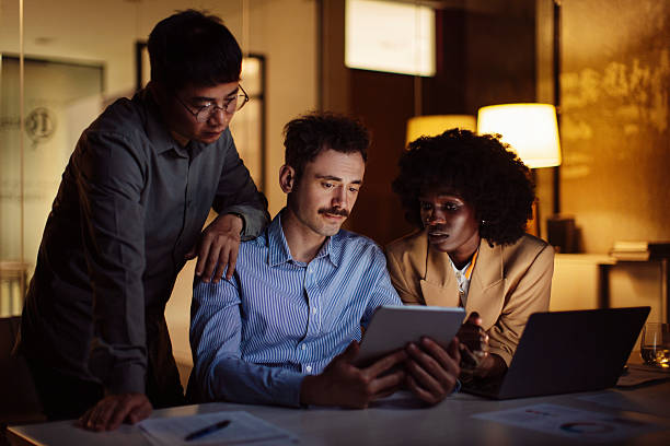 istock Focused Business Team Working Together Late in a Modern Office Space 2238093358