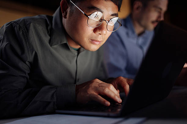 istock Focused Professional Working Late at Night on a Black Laptop 2238093397