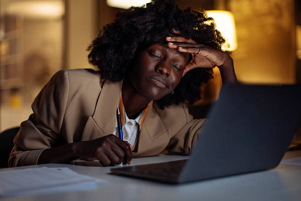 istock Exhausted Professional Working Late at Night in Dimly Lit Office 2238093448
