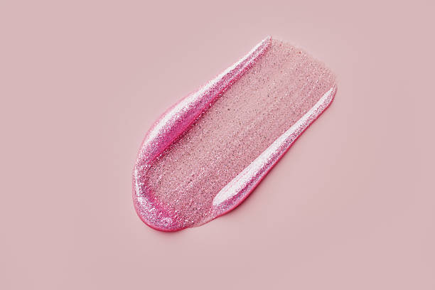 istock Glittery pink lip gloss smear on soft pink background 2238098055