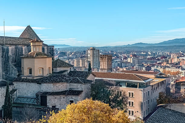 Panoramic cityscape of Girona, Spain, capturing the harmonious blend of ancient stone architecture and modern urban development