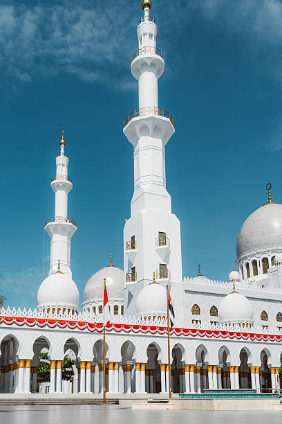 istock Beautiful white mosque with minarets under blue sky 2238104347