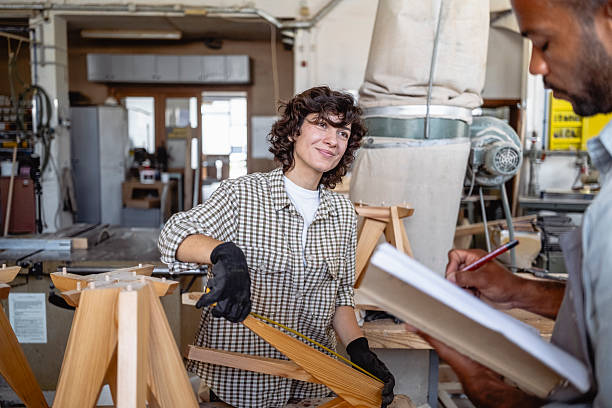 istock Diverse Male and Female Carpenters Collaborating in Workshop Measuring and Taking Notes 2238108073