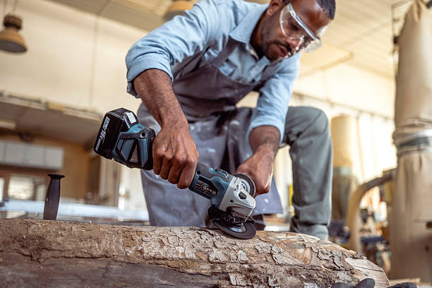 istock Focused Artist Sculpting a Wooden Log in a Bright Workshop 2238108094