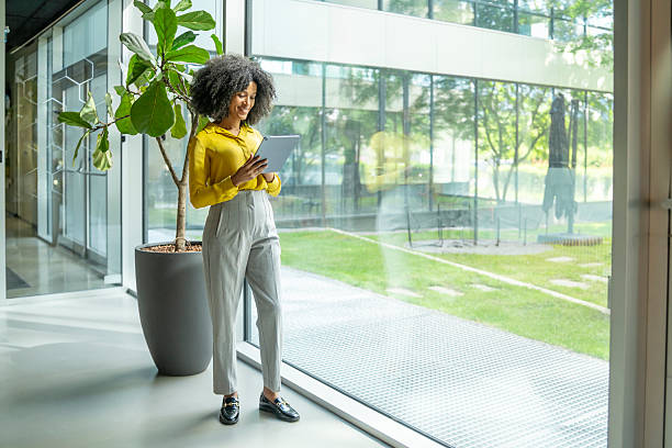 istock Young businesswoman using digital tablet in modern office building 2238108221