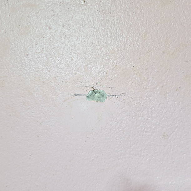 istock Damaged Wall Surface With Concrete Crack Hole And Scratched Paint Detail 2238109720