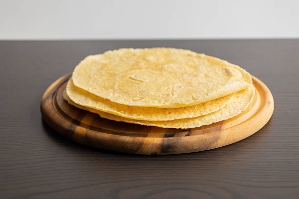 istock Corn Tortillas Stacked on Round Wooden Cutting Board 2238109808