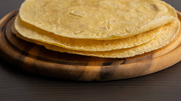 istock Corn Tortillas Stacked on Round Wooden Cutting Board 2238109813